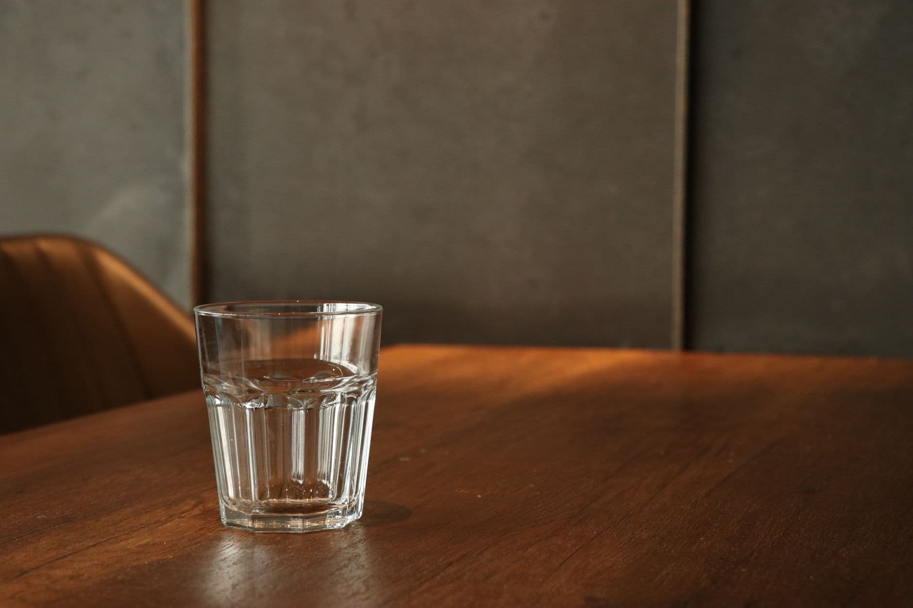 A glass of water on a wooden table