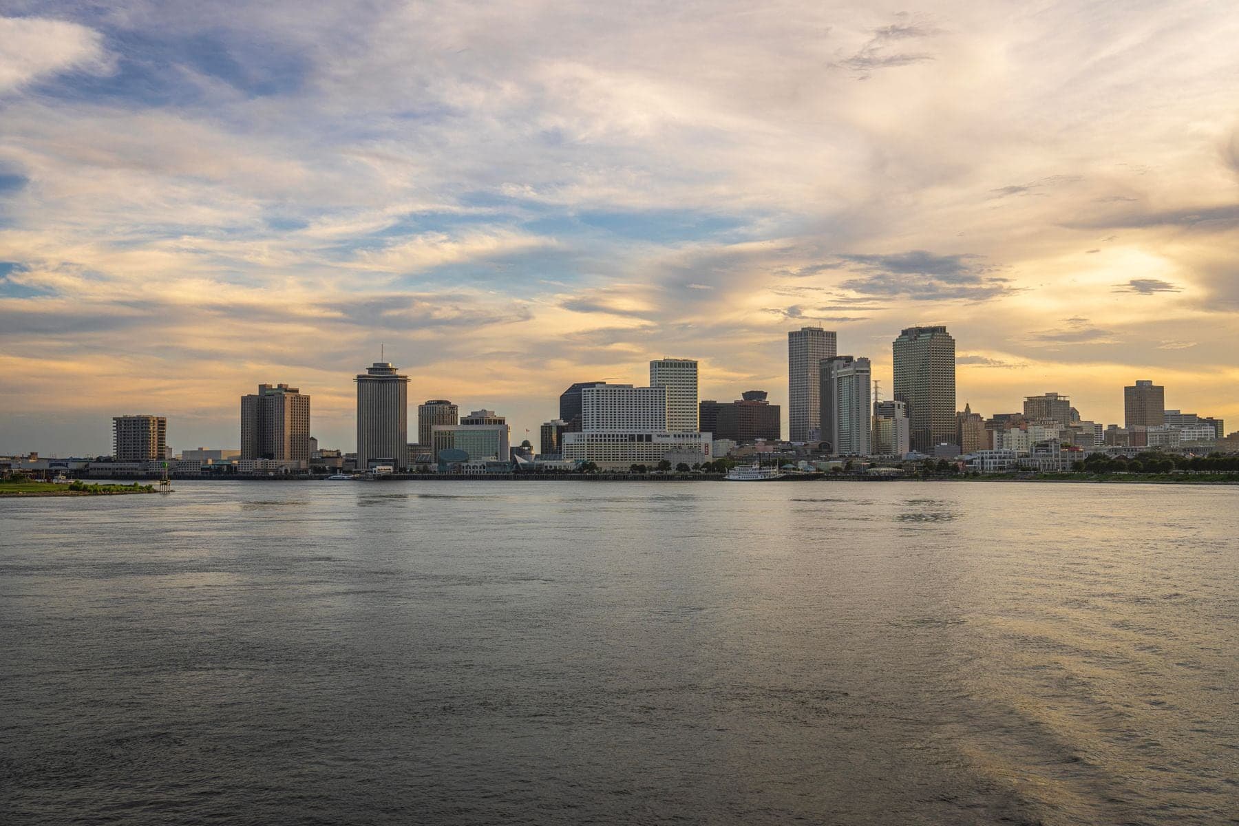 New Orleans skyline across the Mississippi River at sunset